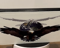 a wallet with an eagle and the earth on it