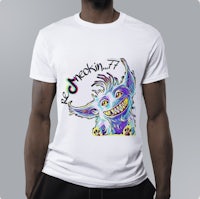 a man wearing a white t - shirt with a colorful monster on it